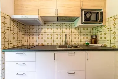 a kitchen with a sink and a microwave at Casa Mirabella in Sottoguda