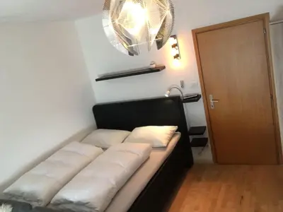 a couch with pillows on it in a room at sonnige schicke Ferienwohnung Meran Pienzenau in Merano