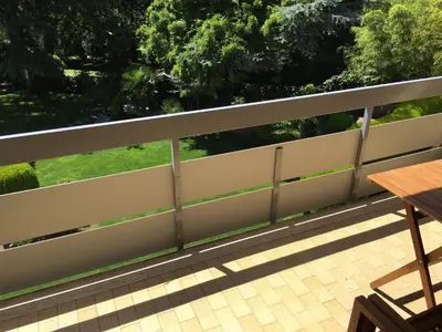 a fence on top of a patio with a table at sonnige schicke Ferienwohnung Meran Pienzenau in Merano