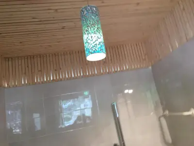 a light hanging from a ceiling in a room at sonnige schicke Ferienwohnung Meran Pienzenau in Merano