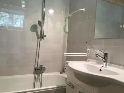 a bathroom with a tub and a sink and a shower at sonnige schicke Ferienwohnung Meran Pienzenau in Merano