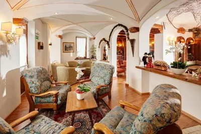 a living room with chairs and a table at Hotel Columbia & Spa in Cortina dʼAmpezzo