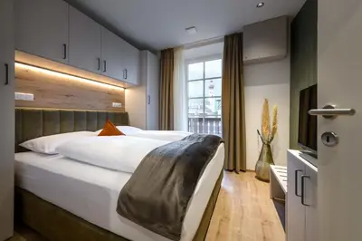 a bedroom with a large bed with a large headboard at Villa Fauster Pustrabase in Villabassa