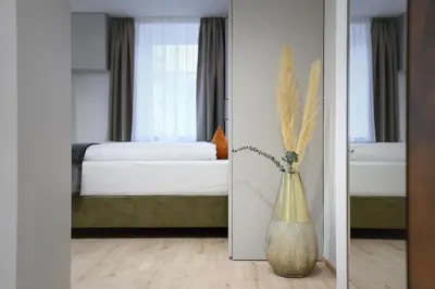 a bedroom with a bed and a vase of flowers at Villa Fauster Pustrabase in Villabassa