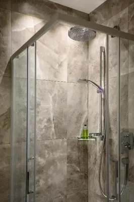a shower with a glass door in a bathroom at Villa Fauster Pustrabase in Villabassa