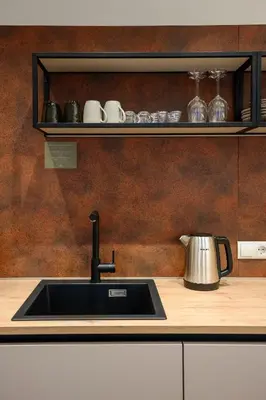a kitchen with a sink and a counter with a tea kettle at Villa Fauster Pustrabase in Villabassa
