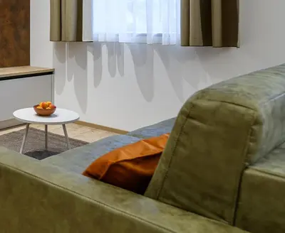 a living room with a couch and a table at Villa Fauster Pustrabase in Villabassa