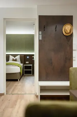 a bedroom with a bed and a hat on the wall at Sambock Quarter Pustrabase in Brunico