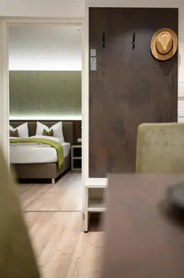 a bedroom with a bed and a hat on the wall at Sambock Quarter Pustrabase in Brunico