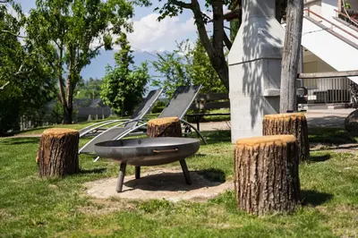 a park with a bunch of trees and a bench at Tribus Lorenz - Wiesgut in Vollan