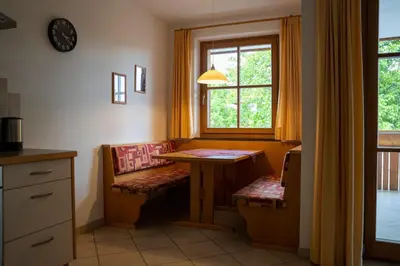 a dining room with a table and a window at Tribus Lorenz - Wiesgut in Vollan