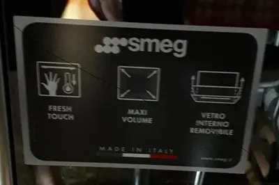 a close up of a sign on a microwave at Casa Antelao in San Vito di Cadore