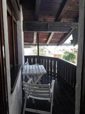 a table and chairs on the porch of a house at Casa Antelao in San Vito di Cadore