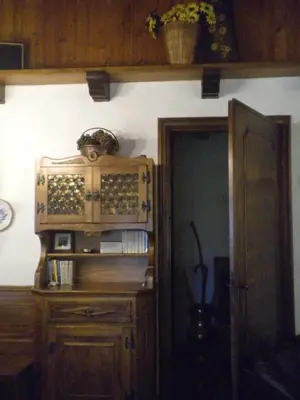 a room with a wooden cabinet with wine bottles on it at Casa Antelao in San Vito di Cadore
