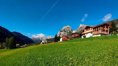 a house on a hill in a green field at Apartments Picenin in La Villa