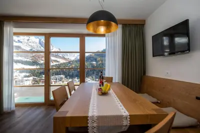 a dining room table with a view of a mountain at Apartments Picenin in La Villa