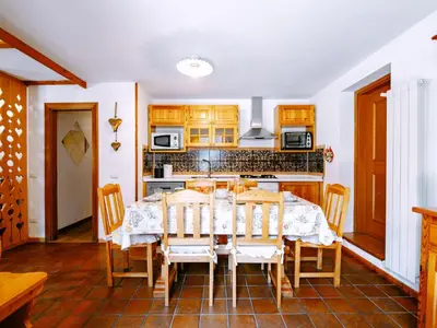 a kitchen with a dining room table and chairs at Apartment Cesa Veja by Interhome in Penia