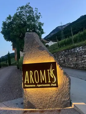 a sign on a rock on the side of a road at Aromis in Termeno