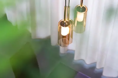 a couple of light fixtures hanging from a window at Aromis in Termeno