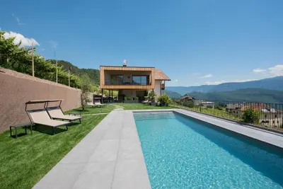 a villa with a swimming pool and a house at Aromis in Termeno