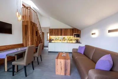a living room with a couch and a table at Aromis in Termeno