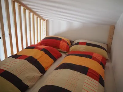 a bed with two pillows on it in a room at Ebner Appartements in Aldino