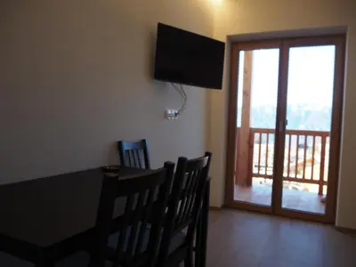 a dining room with a table and chairs and a television at Ebner Appartements in Aldino