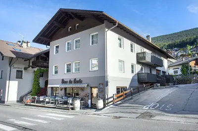 a large white building on the side of a street at Apartments Stua da Carlo in Ortisei