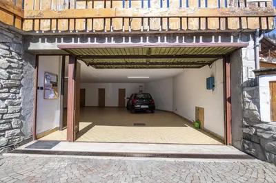 a garage with a car parked inside of it at Apartments Praruf in Selva di Val Gardena