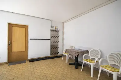 a room with a table and chairs and a door at Apartments Praruf in Selva di Val Gardena