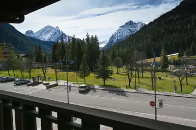 a view of a road with mountains in the background at Casa al Parco Deluxe in Canazei
