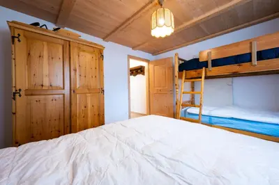 a bedroom with two bunk beds and a closet at Bilocale Fiore in Campitello di Fassa