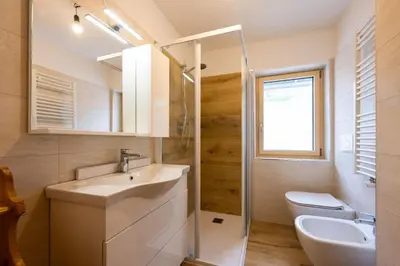 a bathroom with a sink and a toilet at Bilocale Fiore in Campitello di Fassa