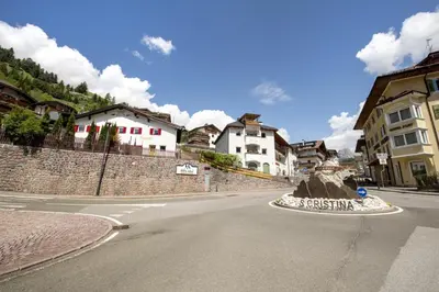 an empty street in a town with houses at Dolomites Apartments Cesa Benedet in Santa Cristina in Val Gardena