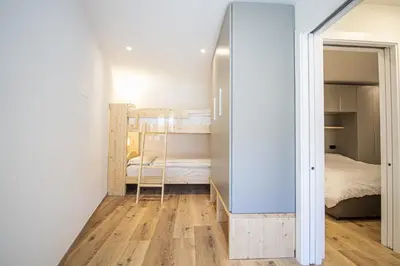 a small bedroom with a bunk bed and a mirror at Dolomites Apartments Cesa Benedet in Santa Cristina in Val Gardena