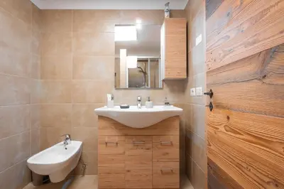 a bathroom with a sink and a mirror at Ciasa de Chica in Pozza di Fassa