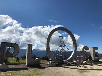a large metal sign that says open with people standing around it at Villa Kranebitt in Bressanone