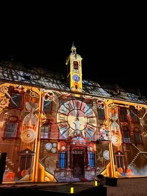 a building with a large clock on the side of it at Villa Kranebitt in Bressanone