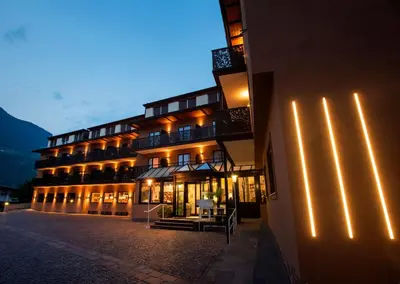 a building with lights on the side of it at Hotel Chrys in Bolzano