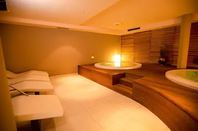 a bathroom with two sinks and a bath tub at Hotel Chrys in Bolzano