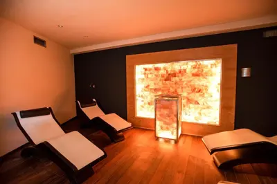 a room with three chairs and a large window at Hotel Chrys in Bolzano