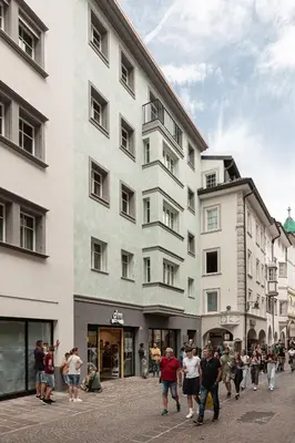 a group of people walking in front of a building at Residence - Palais Hörtenberg in Bolzano