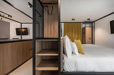 a bedroom with a bunk bed and a television at Residence - Palais Hörtenberg in Bolzano