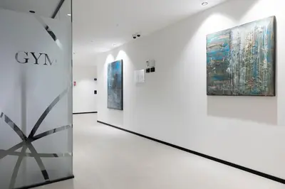a gallery with three paintings on the wall at Residence - Palais Hörtenberg in Bolzano