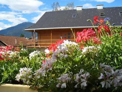 a garden of flowers in front of a house at Tauberhof Apartments in Bressanone