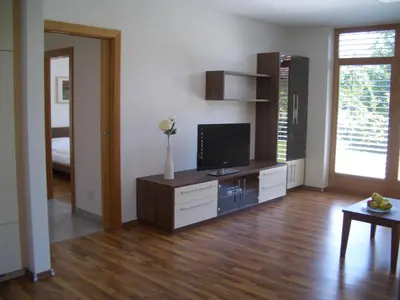 a living room with a television on a dresser at Tauberhof Apartments in Bressanone