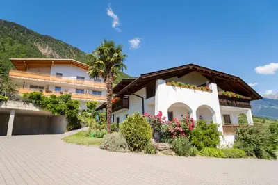 a house in the mountains with a driveway at Unterbrunnerhof in Lana