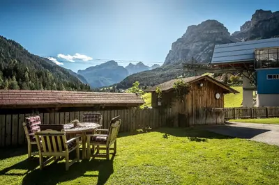 a living room with a table and a couch at Chalet Prades Dolomiti Lodges in La Villa