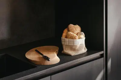 a shelf with a basket of bread and a knife at The Grey Lodge at Bosco Verde in San Cassiano