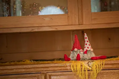 three small red and white gnomes sitting on a shelf at Ciüf de Munt in Badia